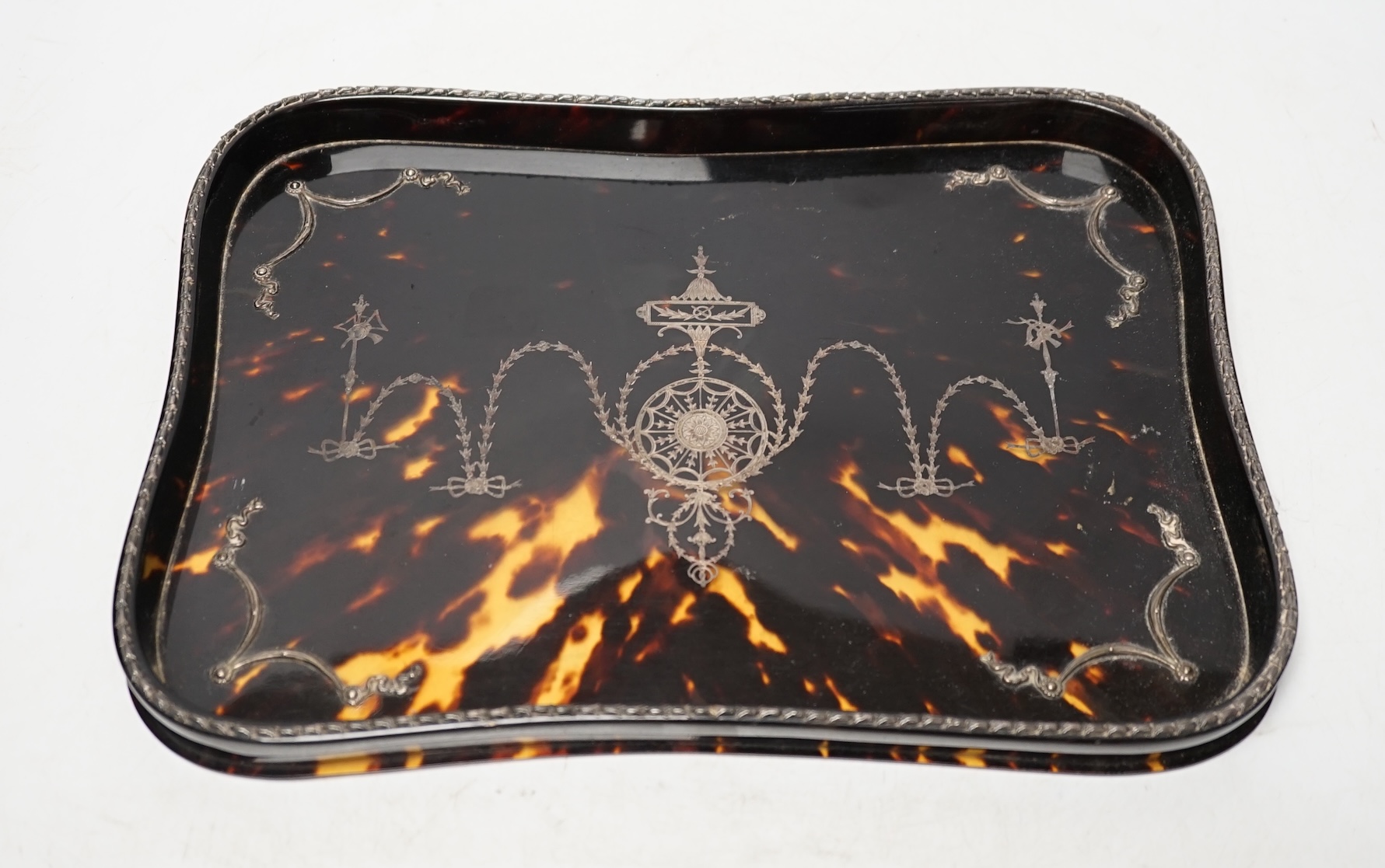 A late 19th century tortoiseshell and white metal pique dressing table tray, 28.8cm. Condition - fair